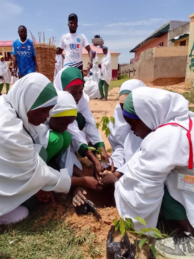 Schoolgirls planting seedlings at the YALI Kano tree-planting project