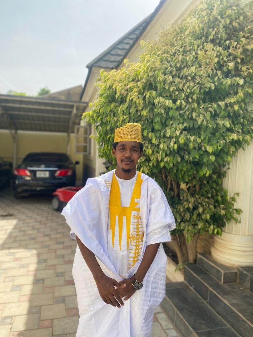 Maharaz Karaye in a white babban riga with gold embroidery